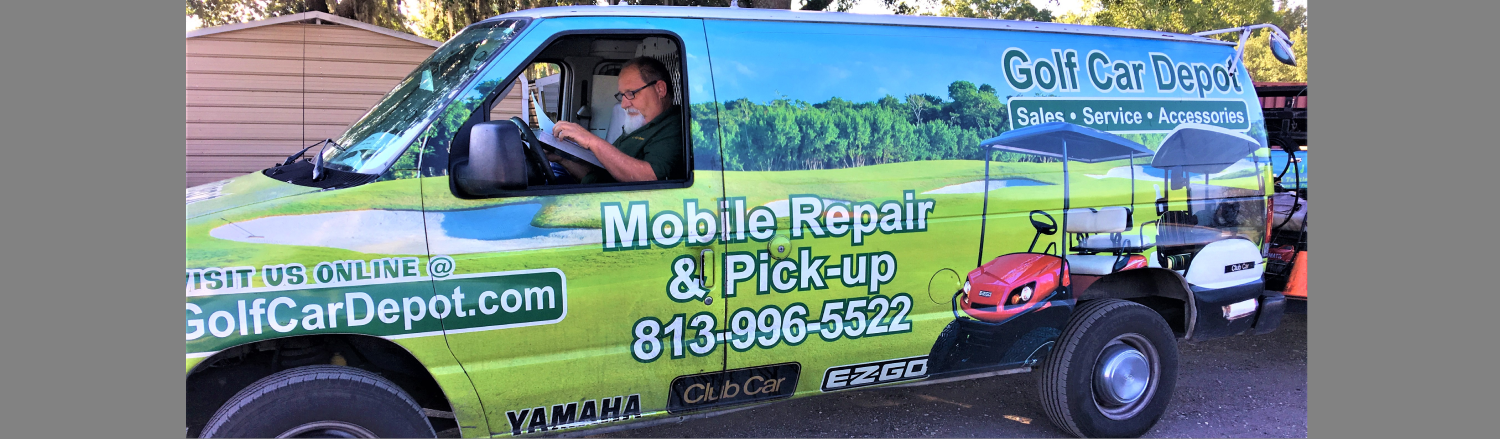Man sitting inside a golf cart mobile pick and repair van.